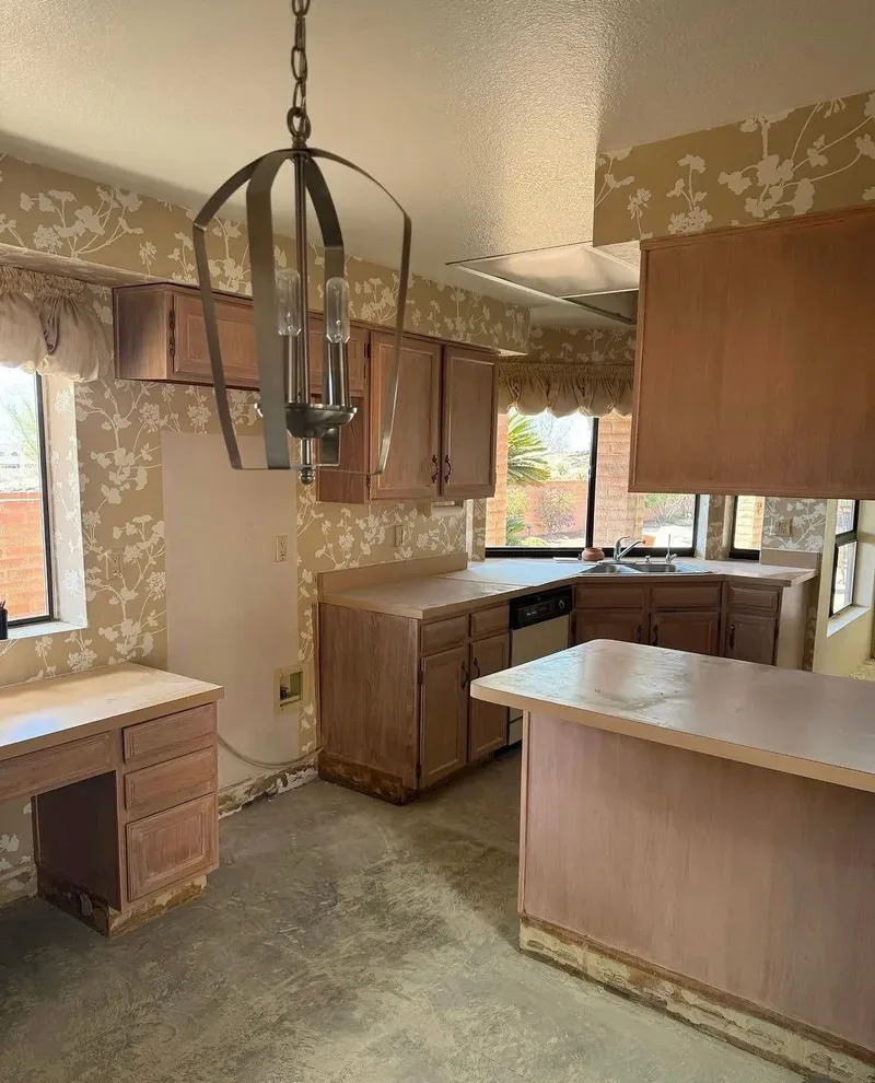 Kitchen before its renovation, with the old flooring already removed