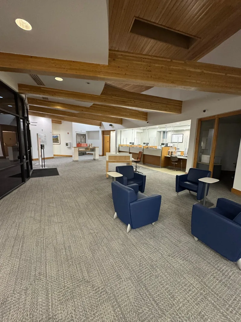 Commercial lobby renovation with a wood-beam ceiling and new carpet