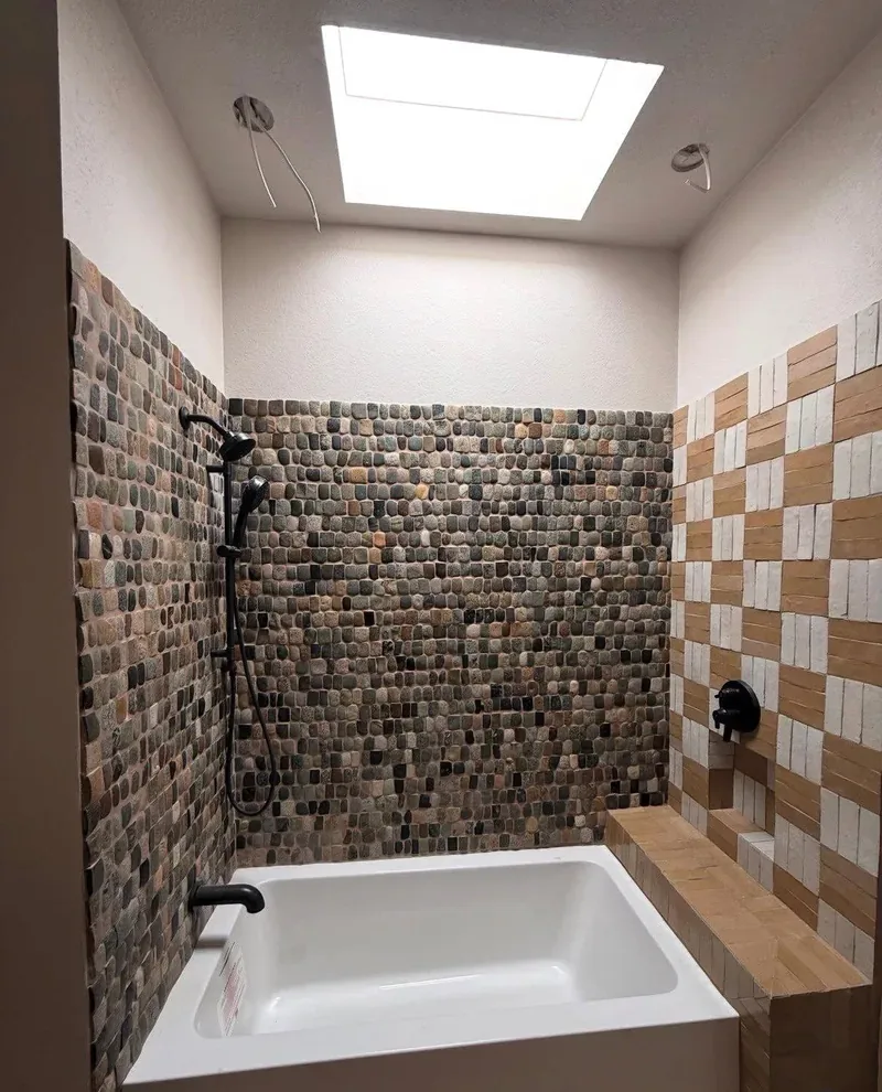 Primary-bath remodel with a freestanding tub and tiled accent wall